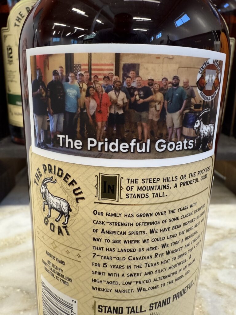 Label on a Prideful Goat whiskey bottle featuring a group photo titled “The Prideful Goats” with a goat logo and printed tasting notes.