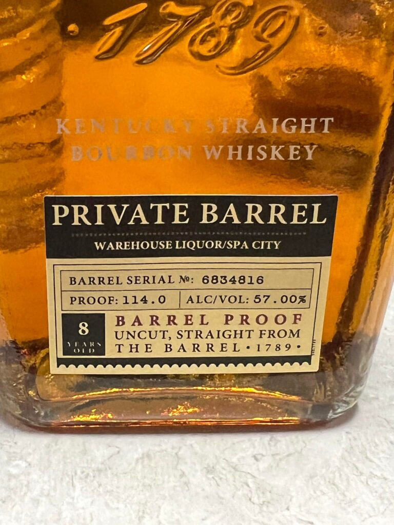 Close-up of a 1789 Kentucky Straight Bourbon Whiskey bottle label reading “Private Barrel,” Warehouse Liquor/Spa City, barrel proof 114.0 (57% ABV), 8 years old.